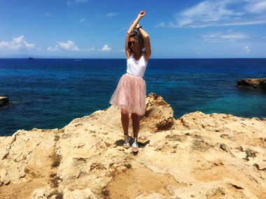 Kıbrıs, Mayıs 2018, Protaras. Deniz kıyısı buzlu bir kız, çok güzel eteği, Rüzgar esiyor