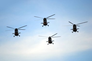 Military helicopters flying in the air clipart
