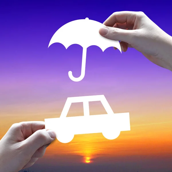Car protection concept, hands, umbrella, sunset sky in backgroun