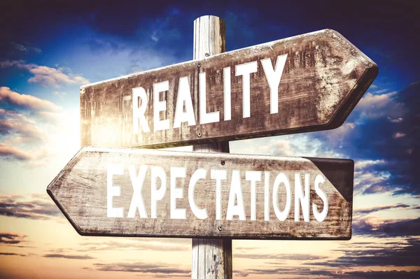 Reality, expectations - wooden signpost, roadsign with two arrows