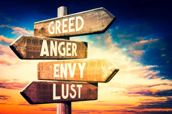 Greed Anger Envy Lust Wooden Signpost Roadsign Four Arrows — Stock Photo, Image
