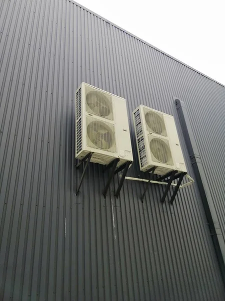Industrial air conditioning, four pieces on a large wall of the building
