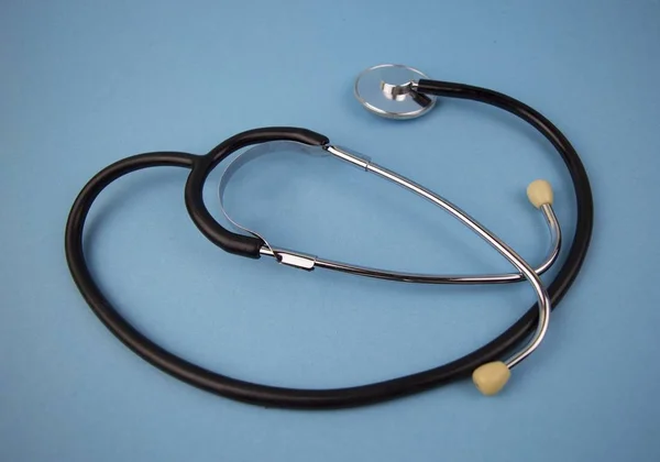Phonendoscope doctor black on a blue background - medicine