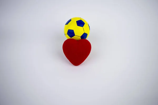 Heart and soccer ball on a white background, there is free space to fill the text