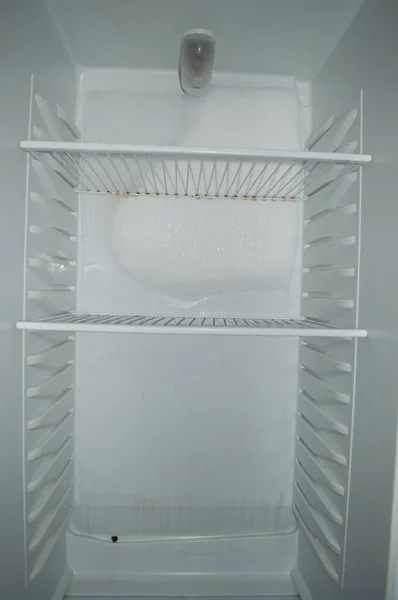 refrigerator repair - frozen block of ice on the fridge wall, white refrigerator