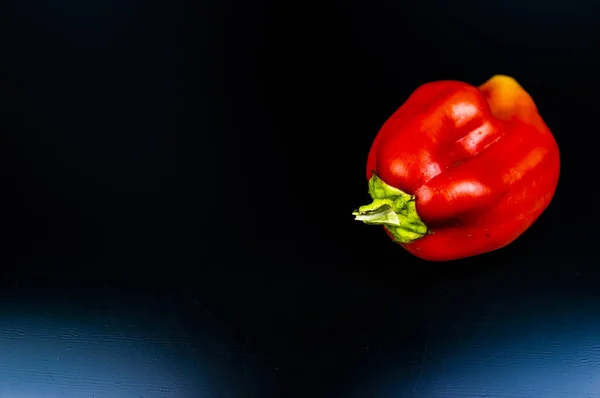 Garden sweet pepper on a black background.
