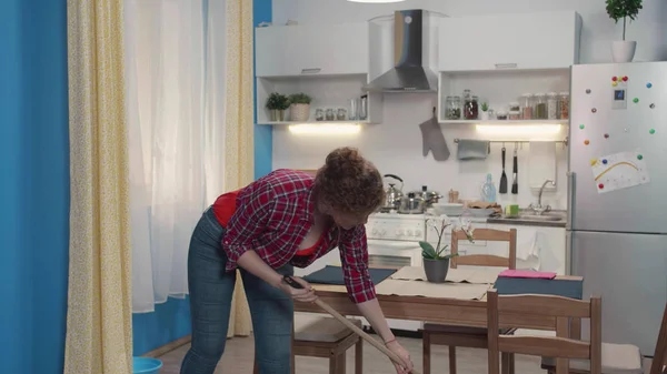 Frau erledigt Hausarbeit mit einem Wischmopp. — Stockfoto
