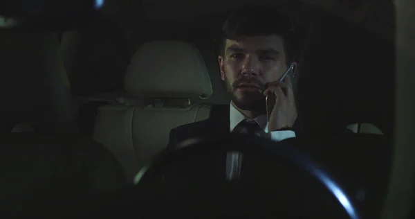 Man talk on phone in car at night. — Stock Photo, Image