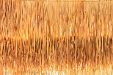 Closeup golden grasses thatch roof for wallpaper. clipart