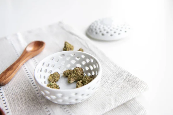 Marijuana Buds Porcelain Bowl Silver Placemat Wooden Spoon Lid Minimalist — Stock Photo, Image