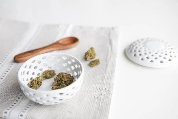 Marijuana Buds Porcelain Bowl Silver Placemat Wooden Spoon Lid Minimalist — Stock Photo, Image