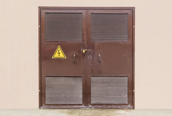 Power substation closed door with high voltage sign