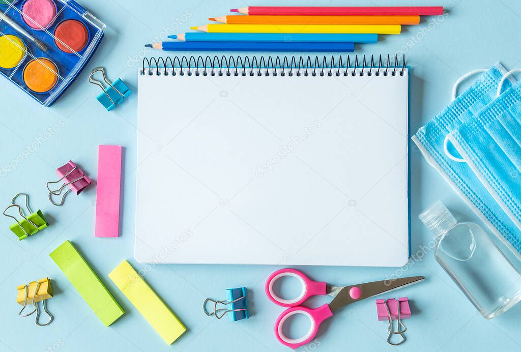 School supplies, colors, notebooks and items for the prevention of coronavirus. Concept of Back to School during the Pandemic. Space for text.
