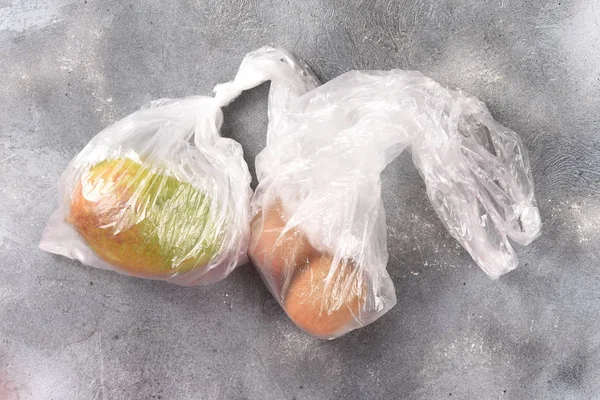 kiwi end mango in plastic bag top view, environmentally harmful plastic bag