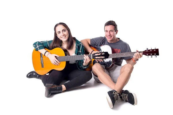 young couple playing the guitars isolated in white