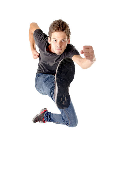 teenage boy jumping isolated in white