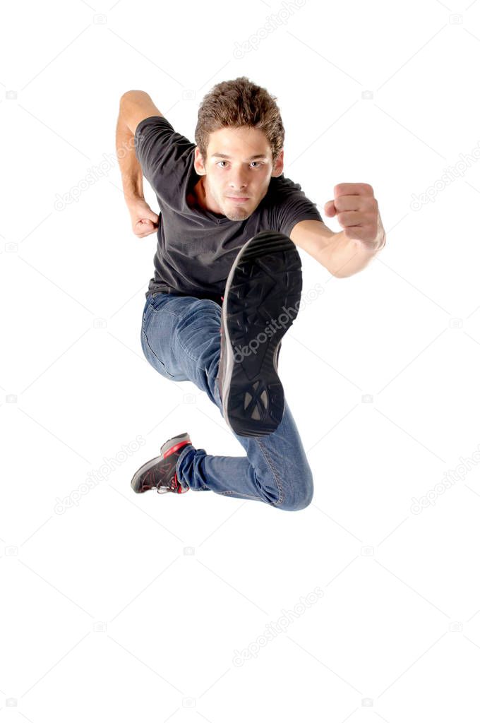 teenage boy jumping isolated in white
