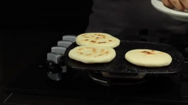 eller kavrulmuş arepa sobayı kaldırma, geleneksel venezuela gıda arepa hazırlık.