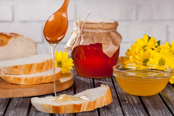 Bal ürünleri, tatlım, peteğin, metin ve ürünler için alanı ile ahşap bir masaya Perge ve yaz çiçek güzel kompozisyon