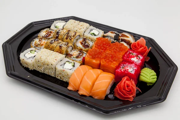 Japanese traditional cuisine, ready-made rolls and sushi in the package, on a white background, for the application and design of fast-food