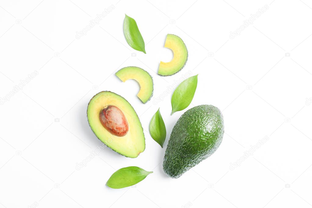 Flat lay composition with ripe avocados on white background, space for text. Top view