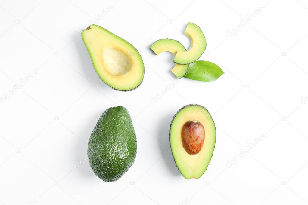 Flat lay composition with ripe avocados on white background, space for text. Top view