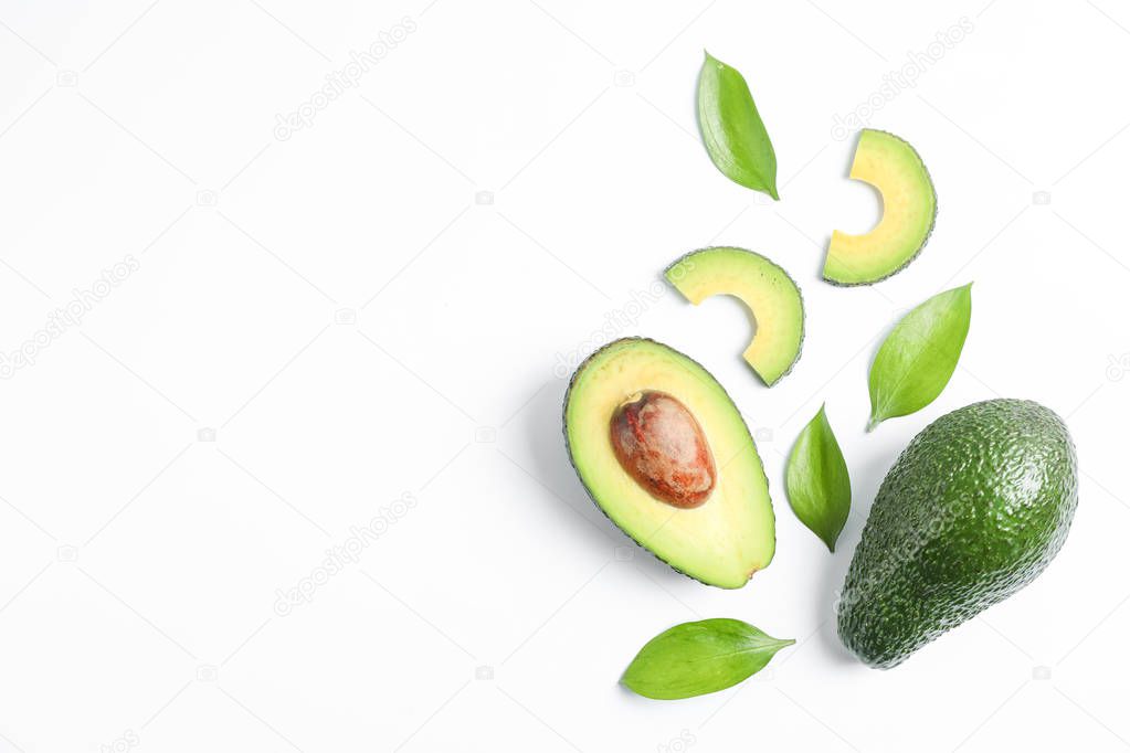 Flat lay composition with ripe avocados on white background, space for text. Top view