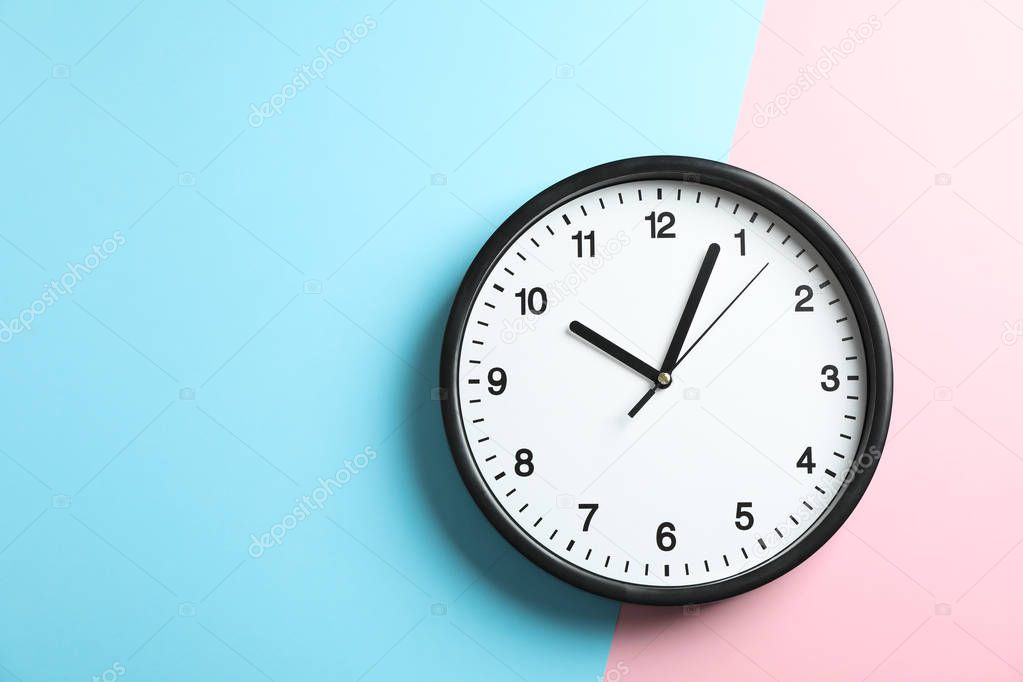 Big beautiful office clock on two tone solid color pink and ligh