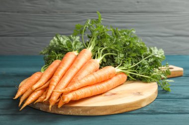 Ahşap masa üzerinde olgunlaşmış havuç ile kesme tahtası