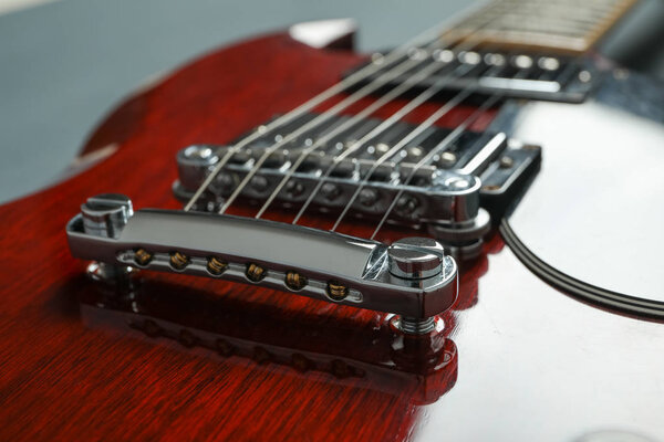 Beautiful six - string electric guitar on dark background, closeup