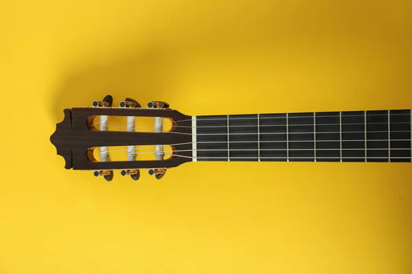 Guitar neck on yellow background, space for text — Stock Photo, Image