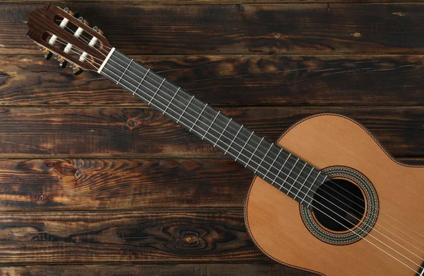 Beautiful six - string classic guitar on wooden background, spac