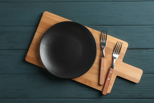 Cutting board and cutlery on wooden background, space for text — Stock Photo, Image