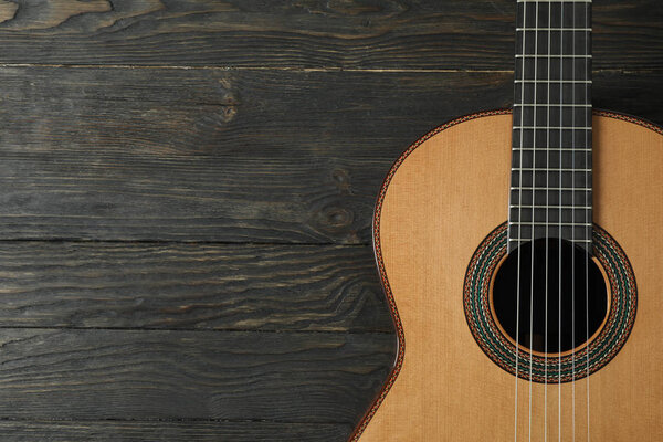 Beautiful six - string classic guitar on wooden background, spac