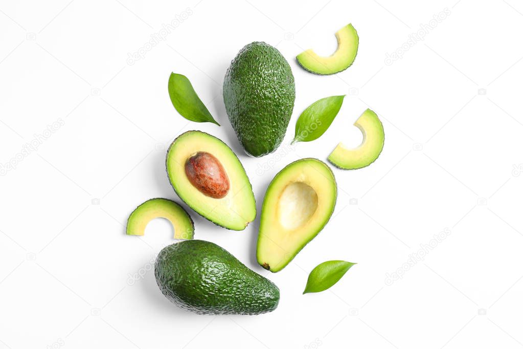 Flat lay composition with ripe avocados and leaves on white back