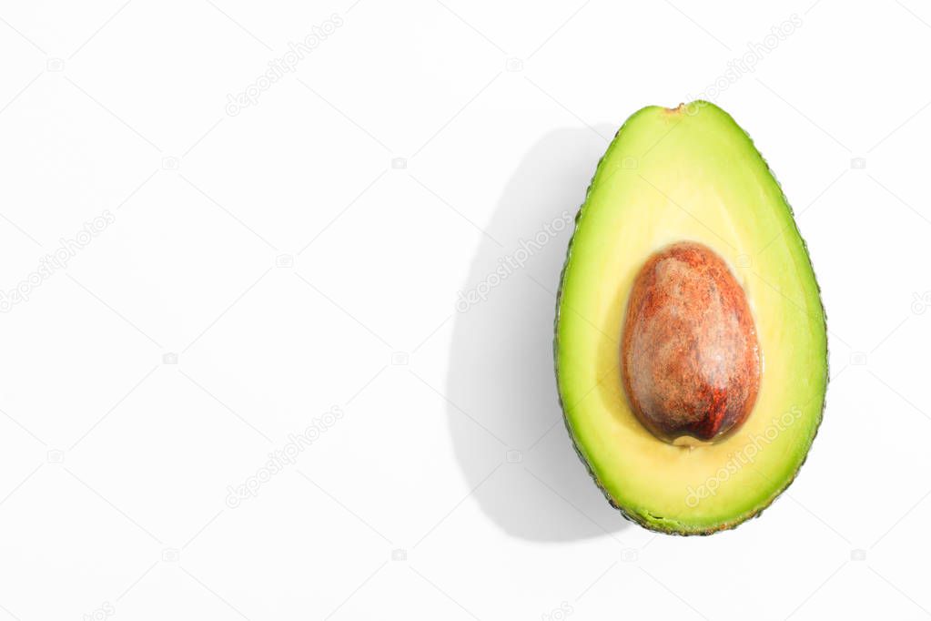 Rip cut avocado on white background, space for text