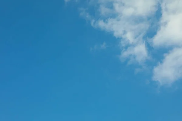 Beautiful white fluffy clouds on a light blue sky background. Wo