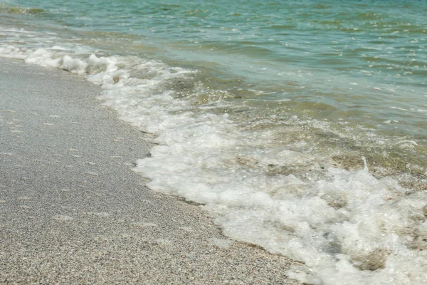 A orillas del mar con olas pequeñas, de cerca. Fondo de verano — Foto de Stock