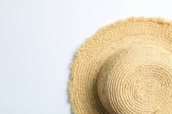 Pretty straw hat on white background. Space for text, top view