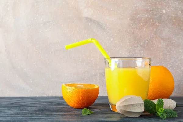 Glass with fresh orange juice and tubule, oranges, mint and wood — Stock Photo, Image