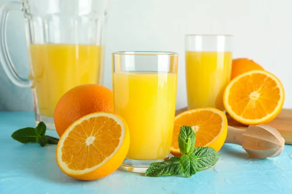 Composition avec jus d'orange frais en verrerie, menthe et bois — Photo