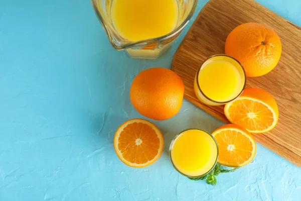 Composition with fresh orange juice in glassware, mint, and cutt — Stock Photo, Image
