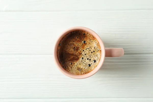 Cup of coffee with frothy foam on wooden background, space for t — Stock Photo, Image