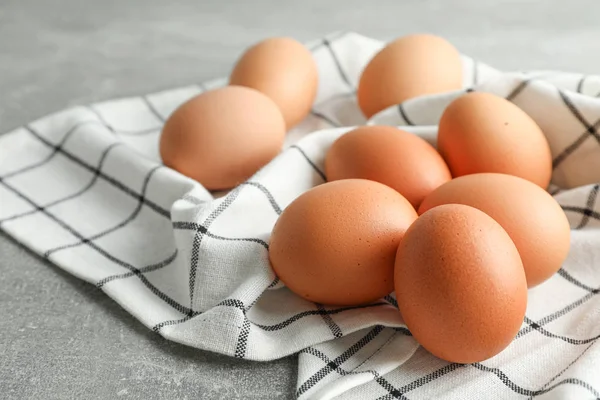 棕色鸡蛋在厨房毛巾灰色背景,空间fo — 图库照片