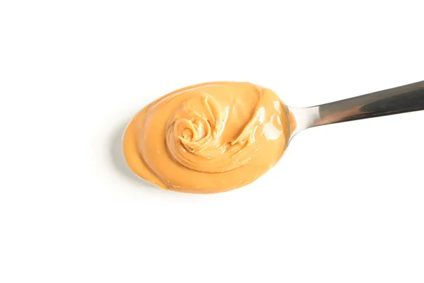 Smetanová arašídové máslo ve lžíce izolované na bílém pozadí, nahoře — Stock fotografie