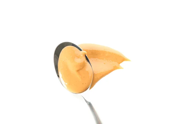 Łyżka z kremowym masłem orzechowym na białym tle, — Zdjęcie stockowe