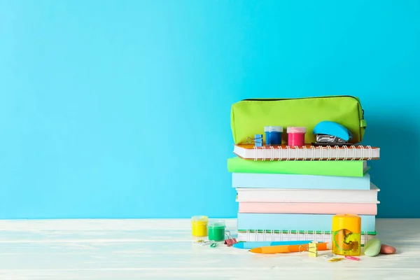 Material escolar na mesa de madeira contra fundo de cor, espaço — Fotografia de Stock
