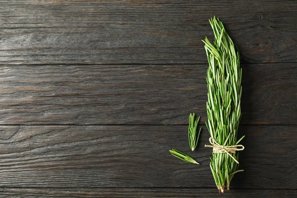 Green rosemary on wooden table, space for text — Stock Photo, Image