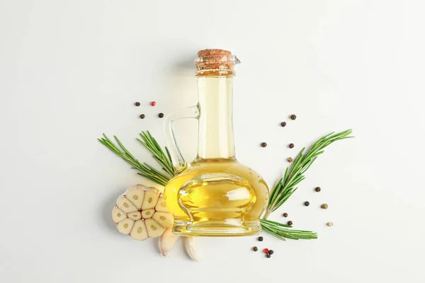 Rosemary oil and leaves, garlic, pepper on white background, top — Stock Photo, Image