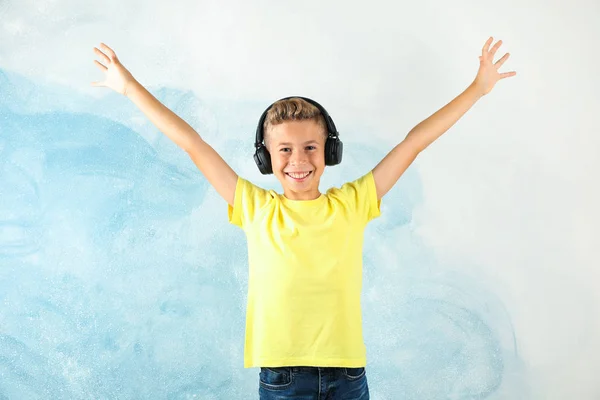 Boy with headphones against color background, space for text — Stock Photo, Image